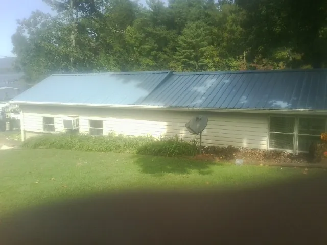 Blue metal roof running the length of a single story home in Harshaw